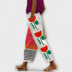 Wide-leg abstract plant printed pants on off-white with red and green blocks