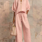 Light pink two-piece blouse and wide-leg pants set with front button placket and tie waist
