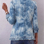 Blue distressed denim jacket back view with button placket and cuffed ruffle hem