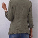 Olive utility jacket back with embroidered floral motifs and button-front design