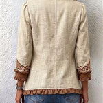 Beige vintage jacket back view with brown embroidered cuffs and scalloped hem