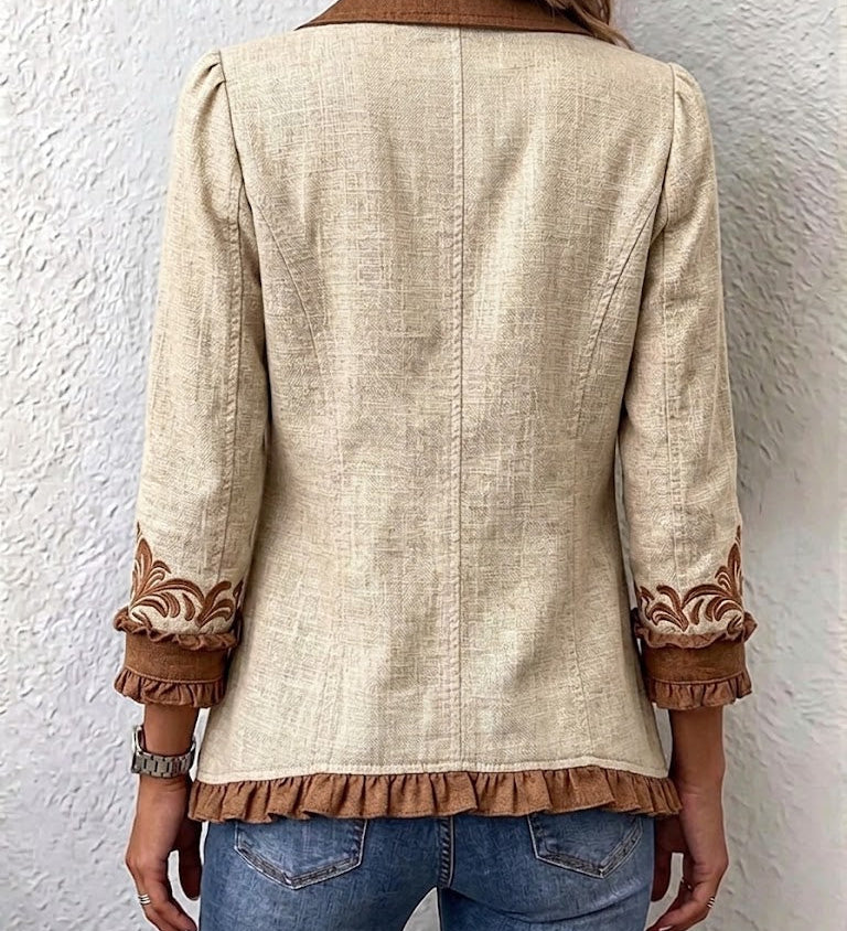 Beige vintage jacket back view with brown embroidered cuffs and scalloped hem