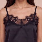Women's dark satin camisole with lace yoke and scalloped trim at neckline.