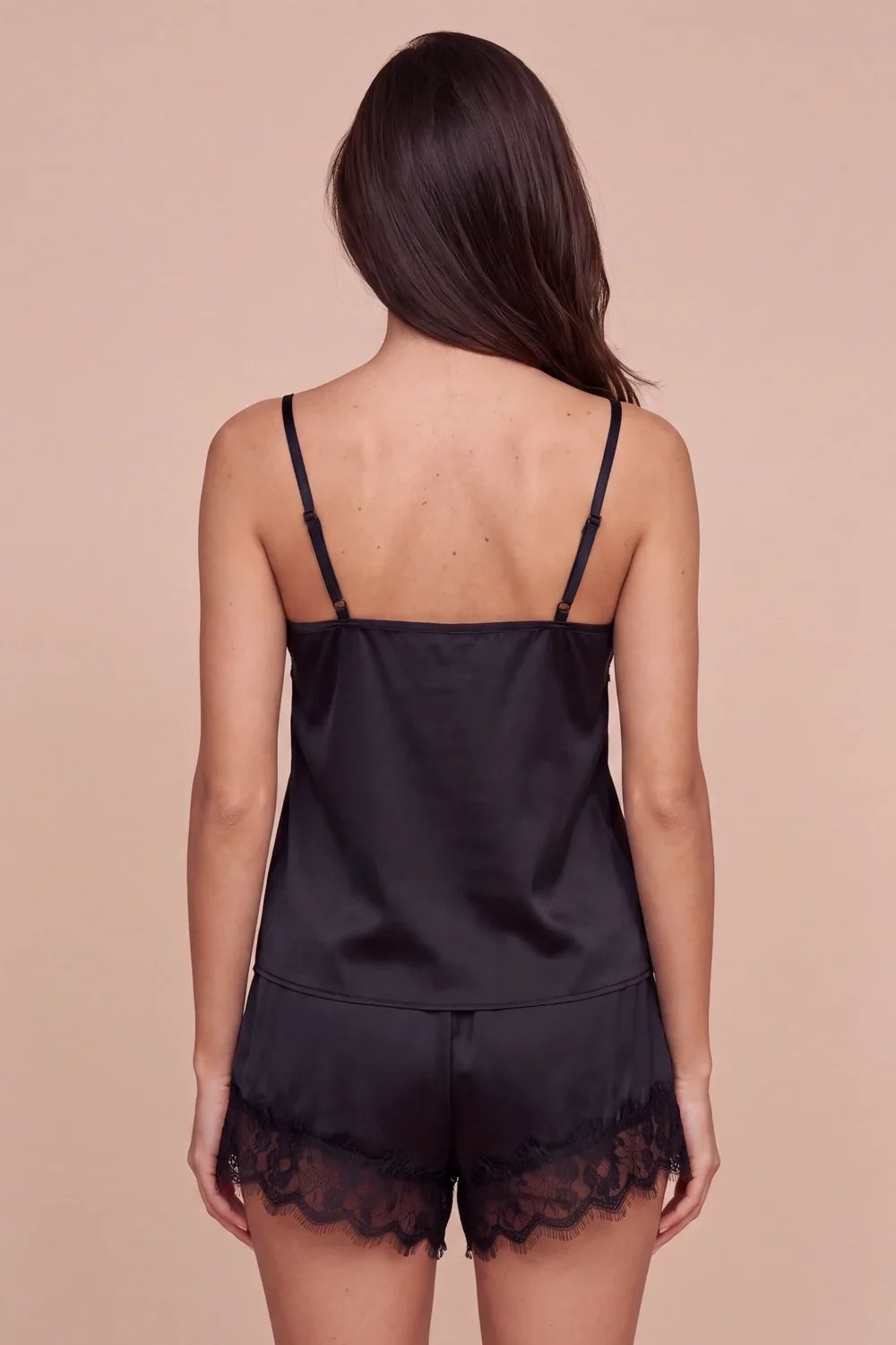 Women's dark satin camisole and lace-trim shorts set, open back with straps.