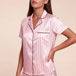 Velias pink-and-white striped short pajama shirt with black trim and matching shorts, side view