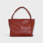 Red leather-look tote bag with two top handles and rectangular front