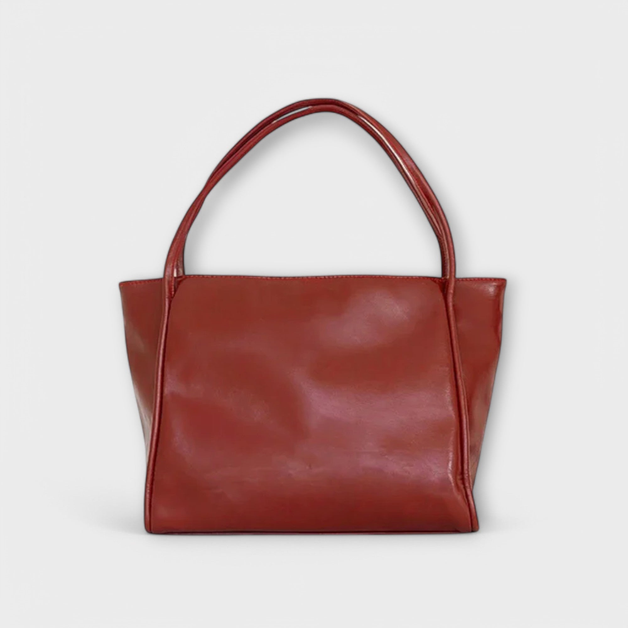Red leather-look tote bag with two top handles and rectangular front