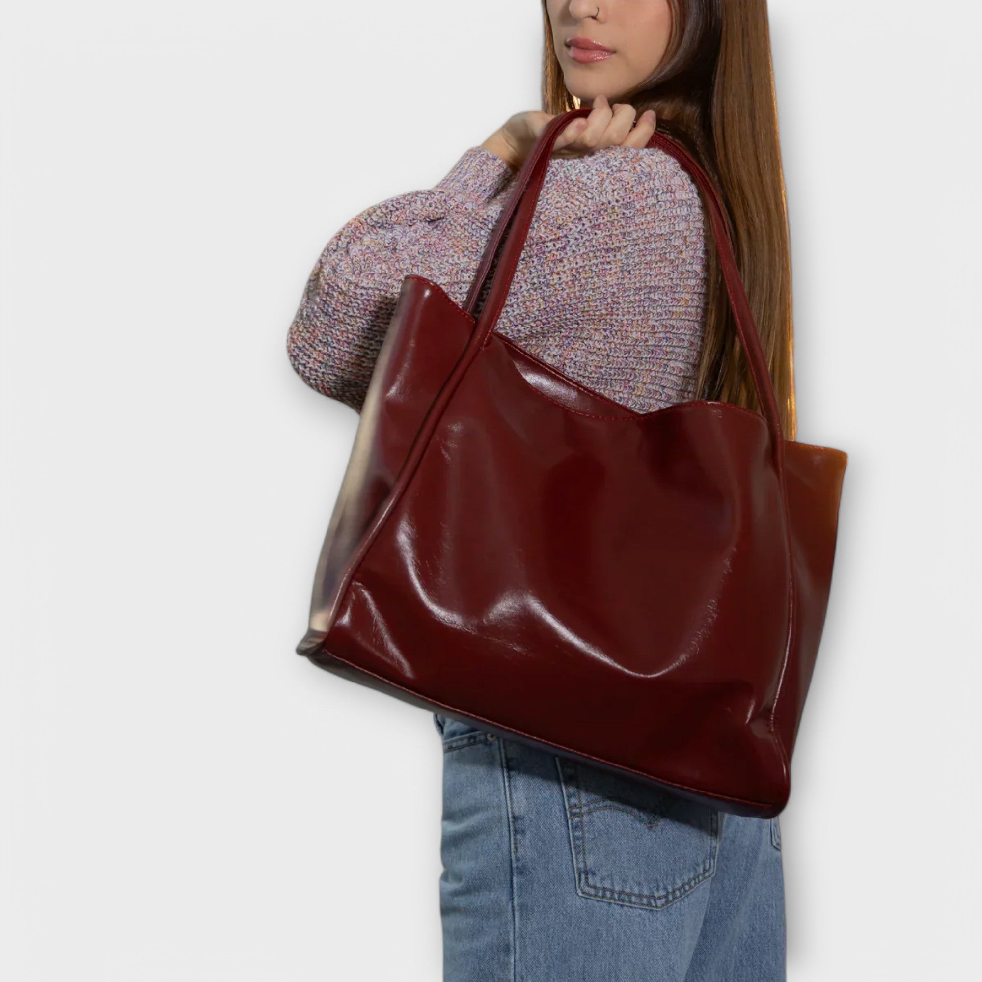 Dark red tote bag with wide top opening and two long leather handles