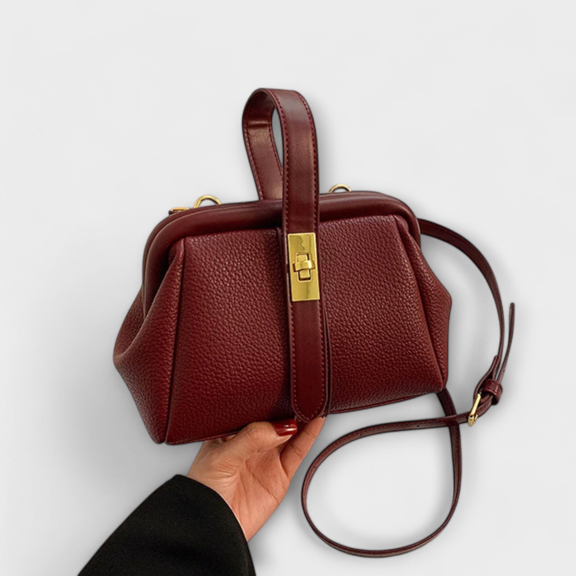Dark red vintage mini bag with gold clasp, top handle, and crossbody strap