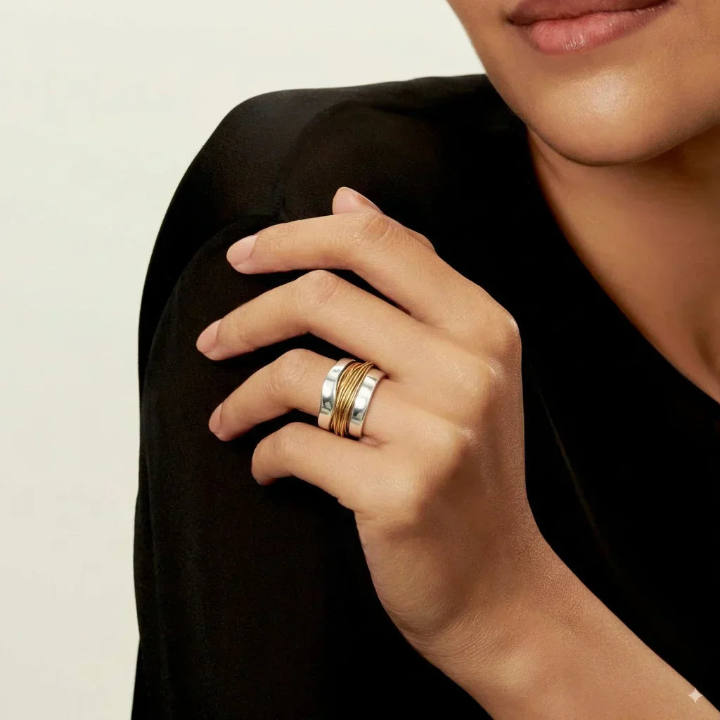 Silver gold-thread ring with stacked bands, worn on finger
