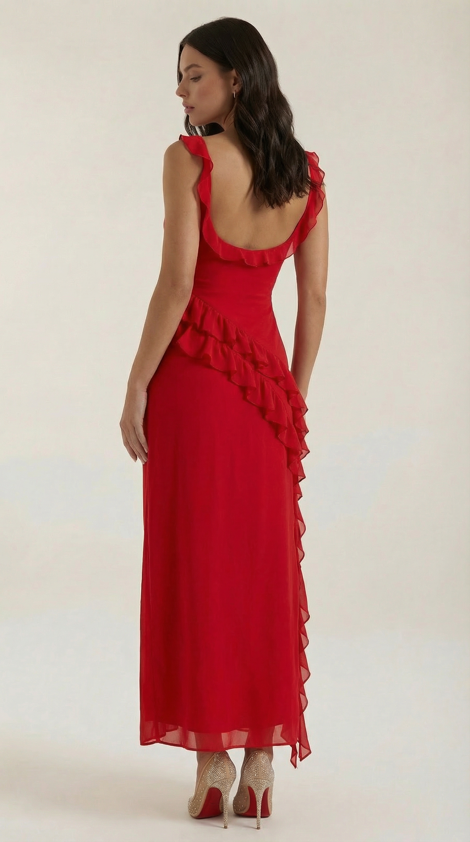 Red elegant dress with thin straps, ruffled waist, and layered asymmetrical skirt