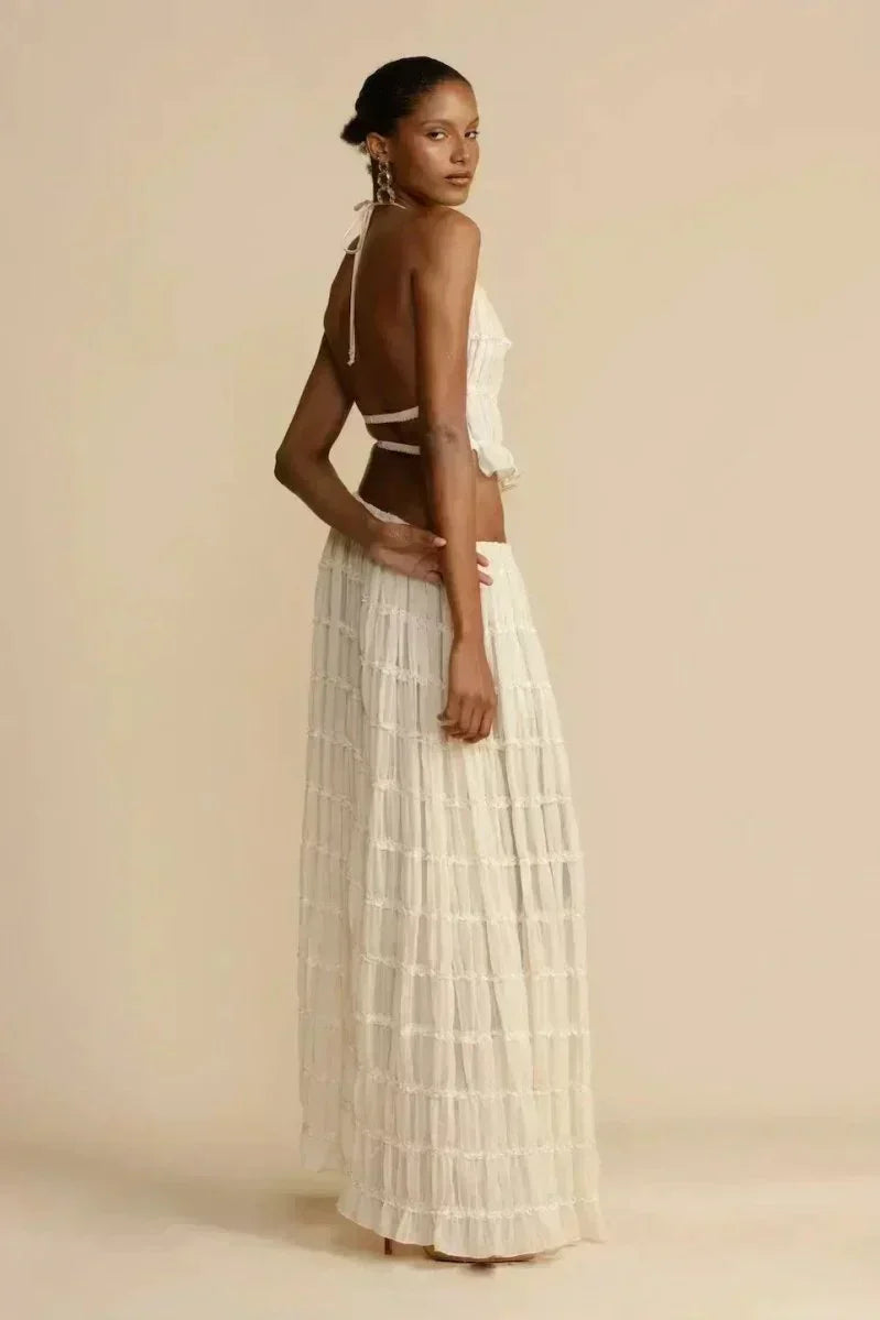 White pleated halter crop top with ruffled tiers, side profile