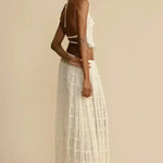 White pleated halter crop top with ruffled tiers, side profile