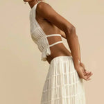 White pleated backless halter crop top with thin crisscross straps, side view