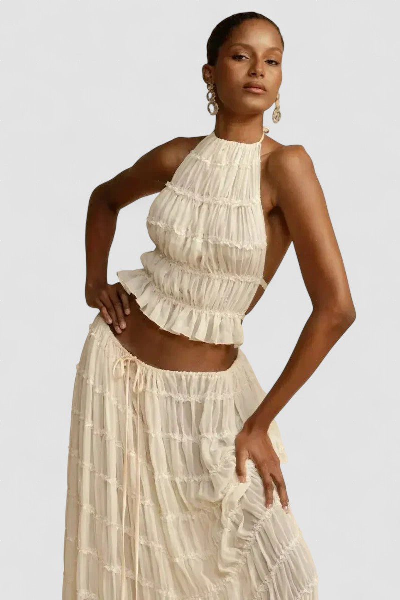 White pleated halter crop top with ruffled tiers and no back coverage