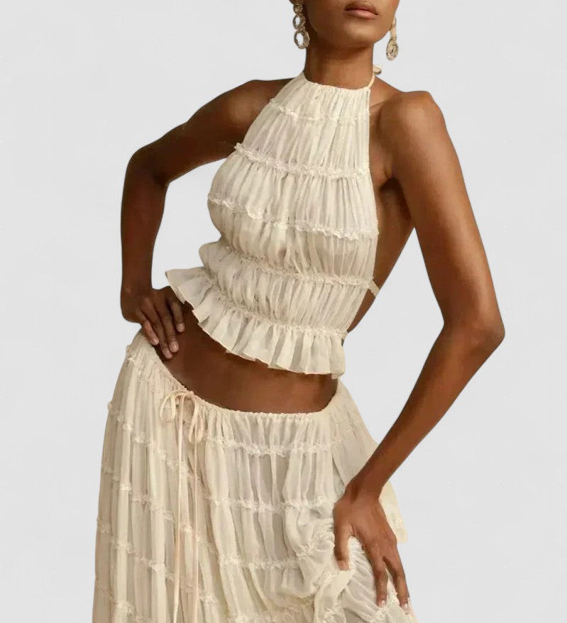 White pleated halter crop top with ruffled tiers and no back coverage