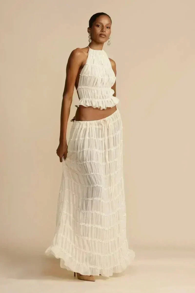 White pleated halter crop top with ruffled tiers, sleeveless cut