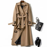 Beige classic trench coat with black inner panels, button front, and tied belt
