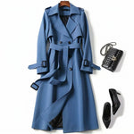 Blue classic trench coat with belted waist, layered lapels, and button front