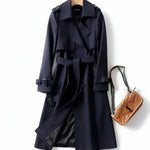 Dark navy classic trench coat with belted waist, button front, and shoulder straps