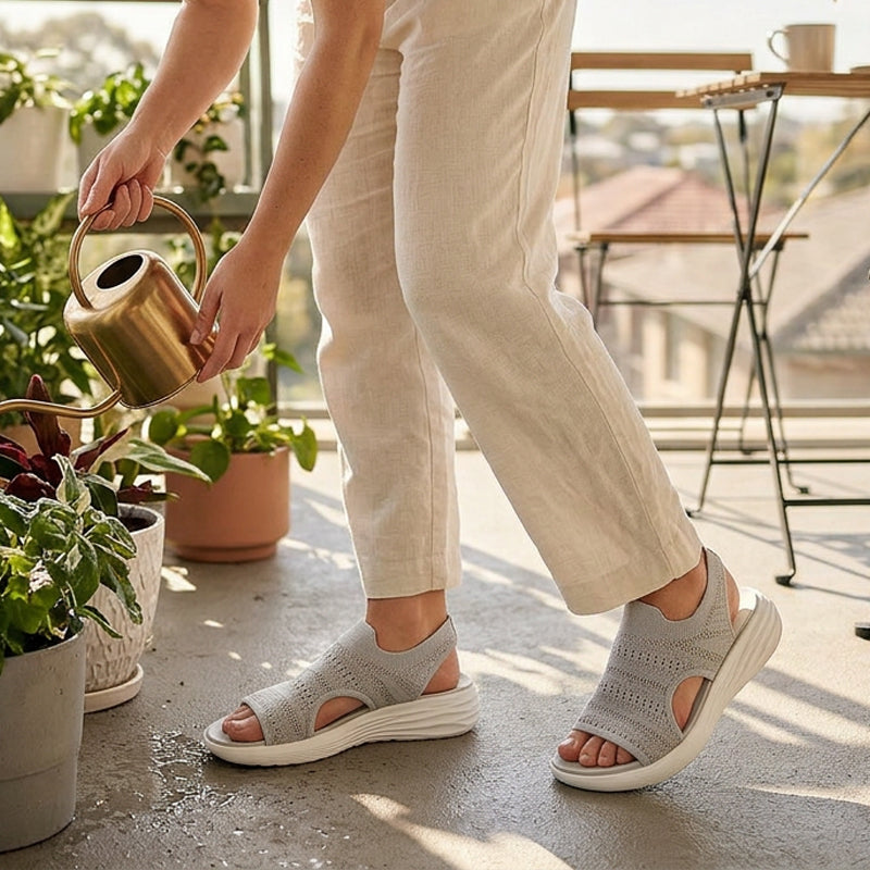 Cream knit open-toe slide sandals with cushioned white sole and side cutouts.