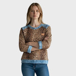 Leopard print long-sleeve top with light denim collar, cuffs, hem and tan chest patch