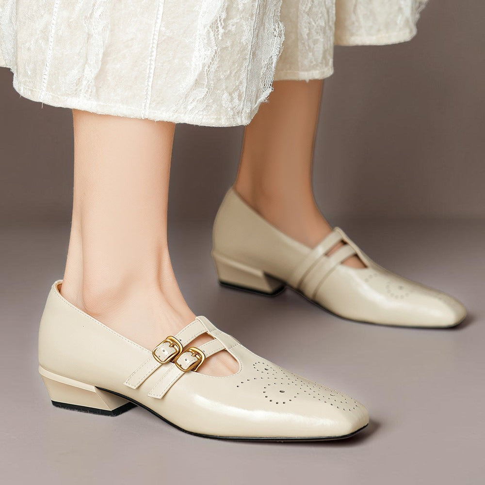Cream Mary Jane shoes with double buckle straps and small broguing perforations