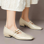 Cream Mary Jane shoes with double buckle straps and small broguing perforations