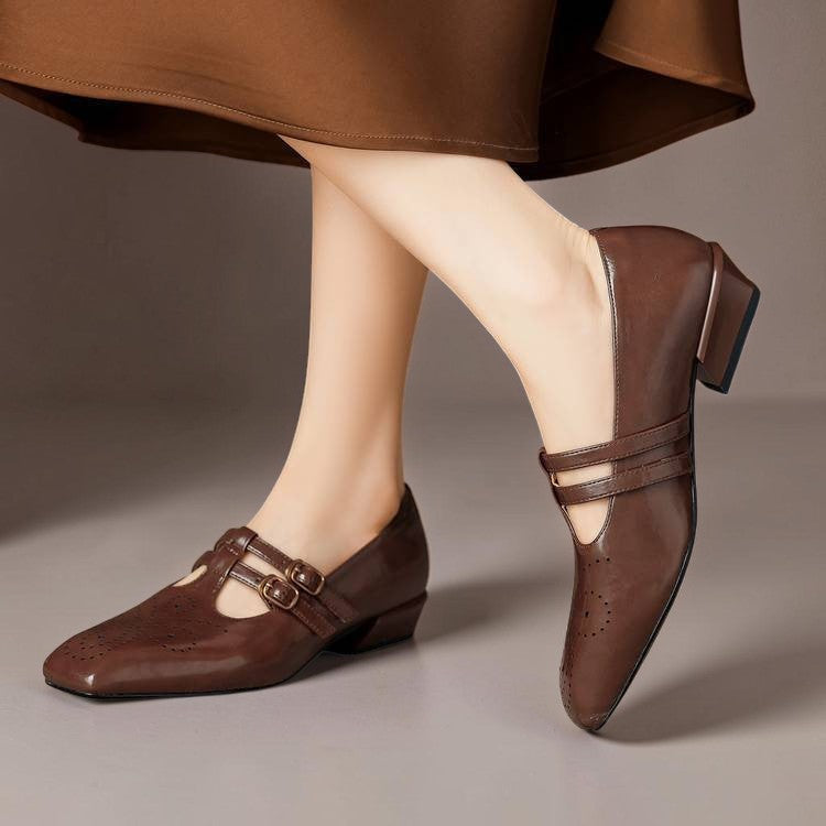 Brown Mary Jane loafers with two strap buckles and broguing perforation pattern