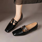 Black Mary Jane shoes with double strap buckles and dotted broguing