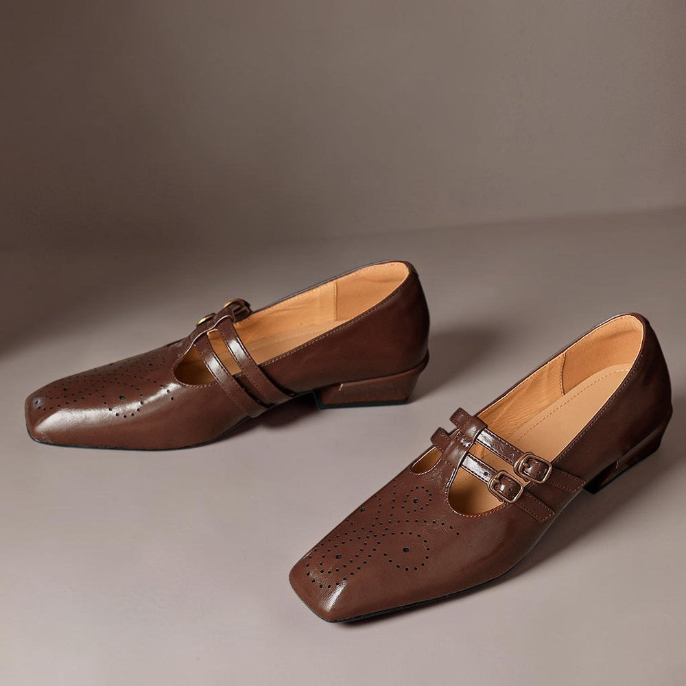 Brown Mary Jane slip-on loafers with double strap buckles and perforated broguing