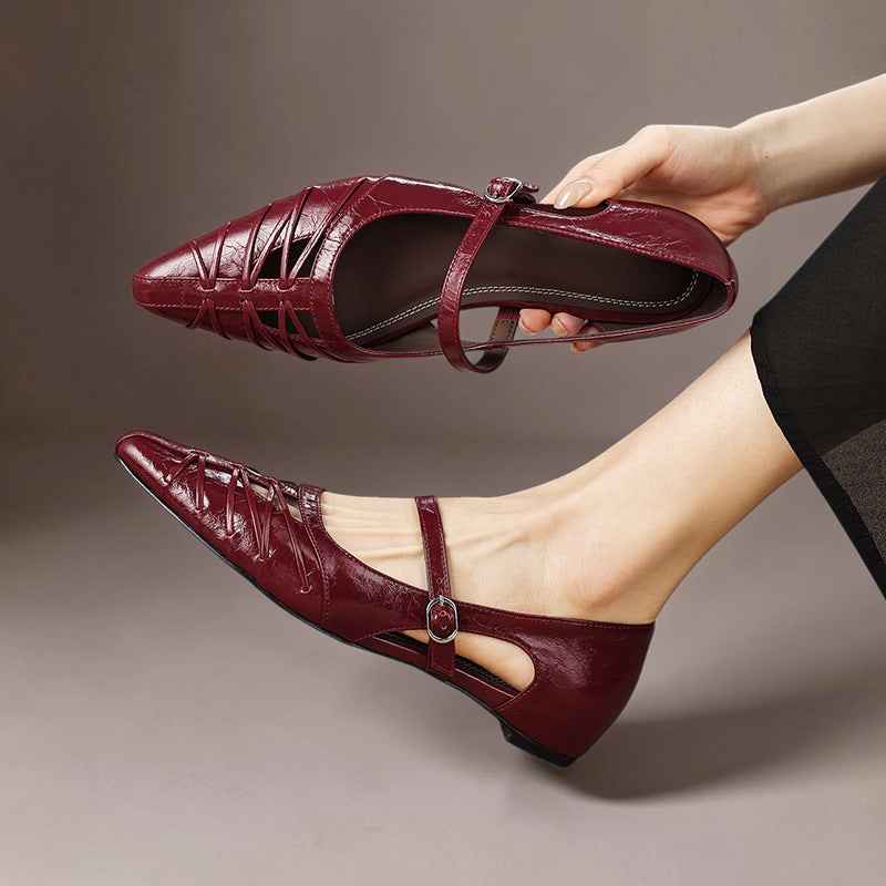 Burgundy Mary Jane flats with ankle strap, buckle detail, and laced upper; pointed toe.
