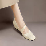 Cream Mary Jane leather flats, side view with low wedge heel and buckle