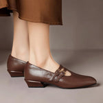 Brown Mary Jane shoes with double buckle strap and broguing perforated toe