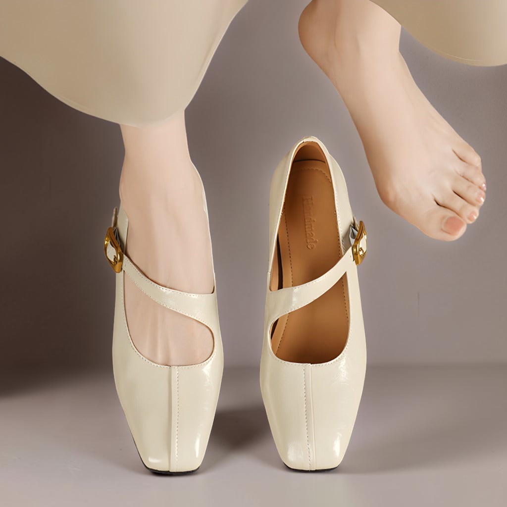 Cream Mary Jane leather flats, top view with gold buckle strap and open front