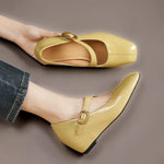 Yellow Mary Jane leather flats with gold buckle strap and low wedge heel