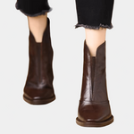 Pair of brown and black ankle boots with medium block heels and side zip closures