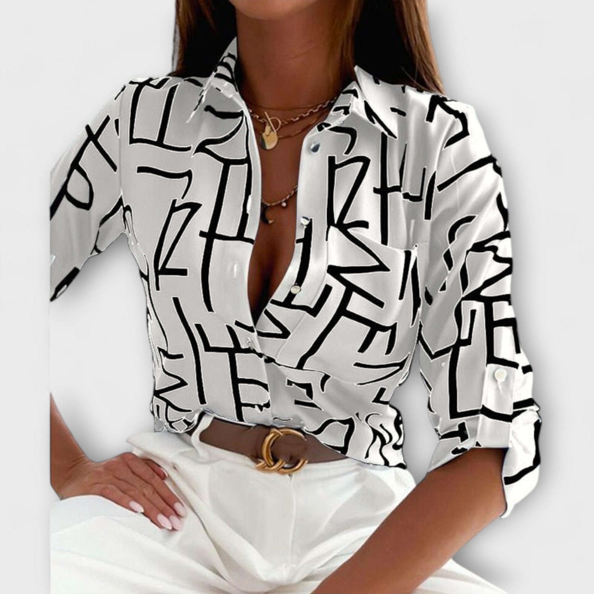 Classic-collar blouse in white with black abstract graphic print, button front.