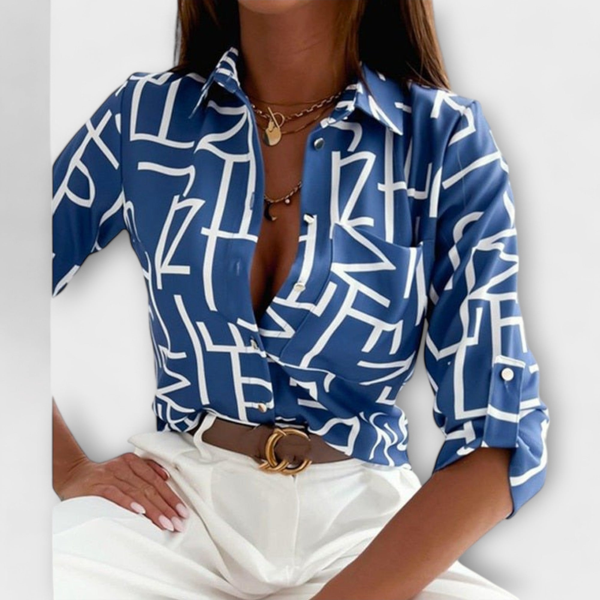 Classic-collar blouse in blue with white abstract graphic print, button front.