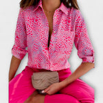 Classic-collar blouse in pink with small heart-like pattern, button front.