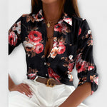 Classic-collar blouse in black with red and white floral print, button front.