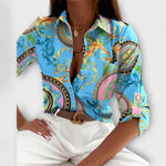 Classic collar button-front blouse with blue ornate paisley print and long sleeves