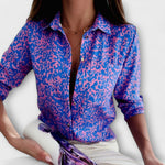 Classic collar button-front blouse with purple animal-style print and long sleeves