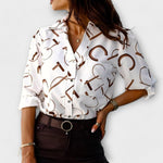 Classic-collar blouse in white with brown abstract symbols, button front.