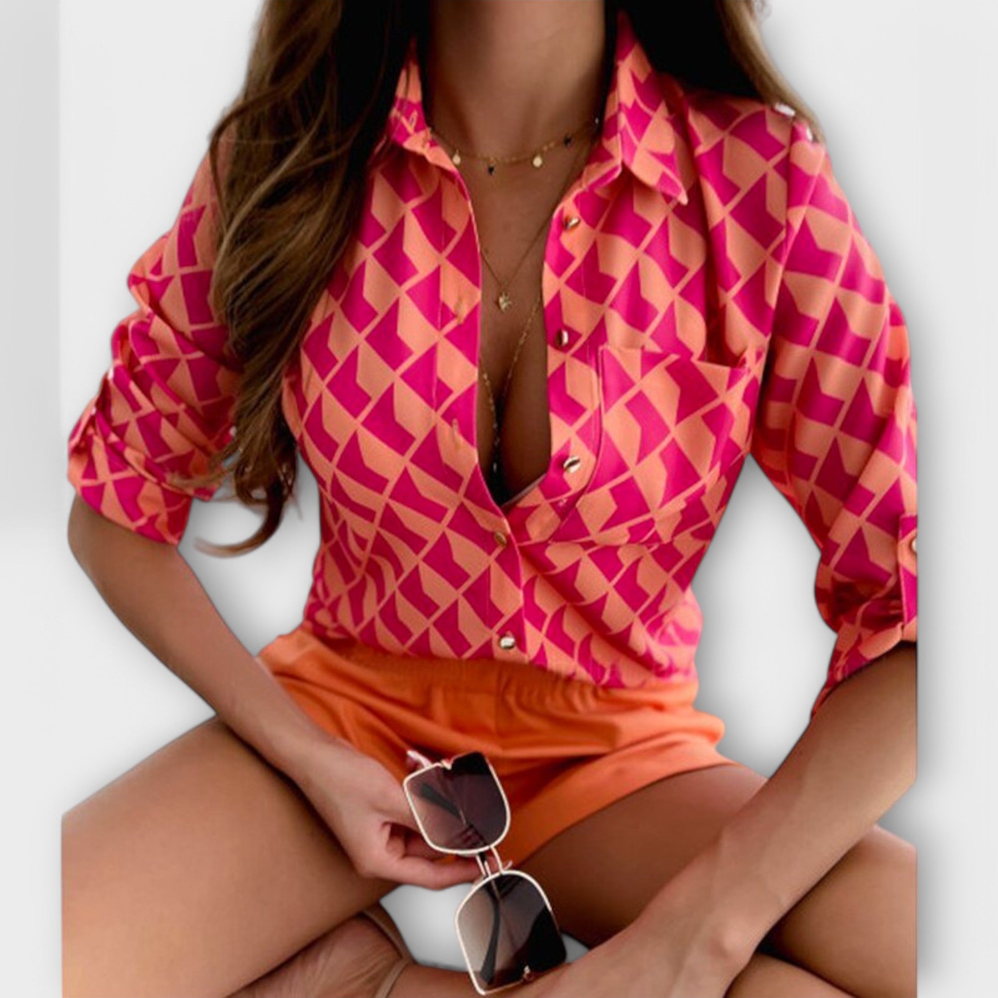 Classic-collar blouse in bright pink with geometric diamond print, button front.
