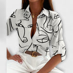 Classic-collar blouse in white with black face line-art print, button front.