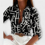 Classic-collar blouse in black with white abstract graphic print, button front.