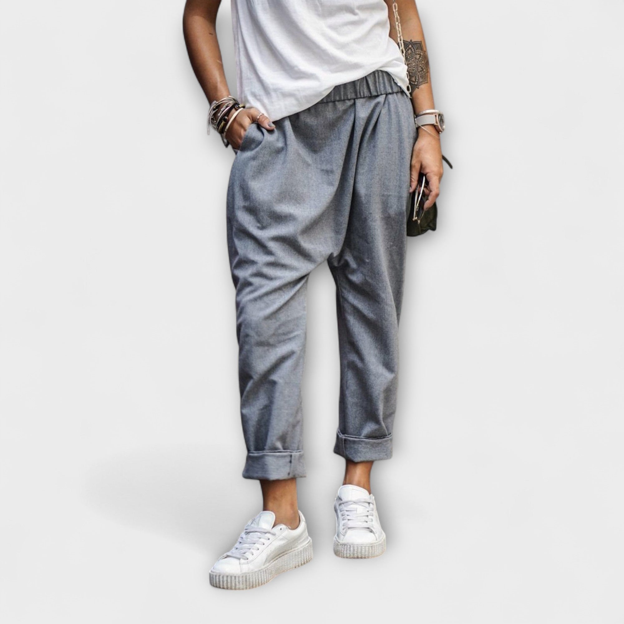 Gray wide-leg ankle-cuffed pants with gathered waist and tapered hem.