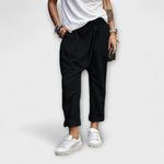 Black wide-leg pants with cuffed ankles and relaxed fit.