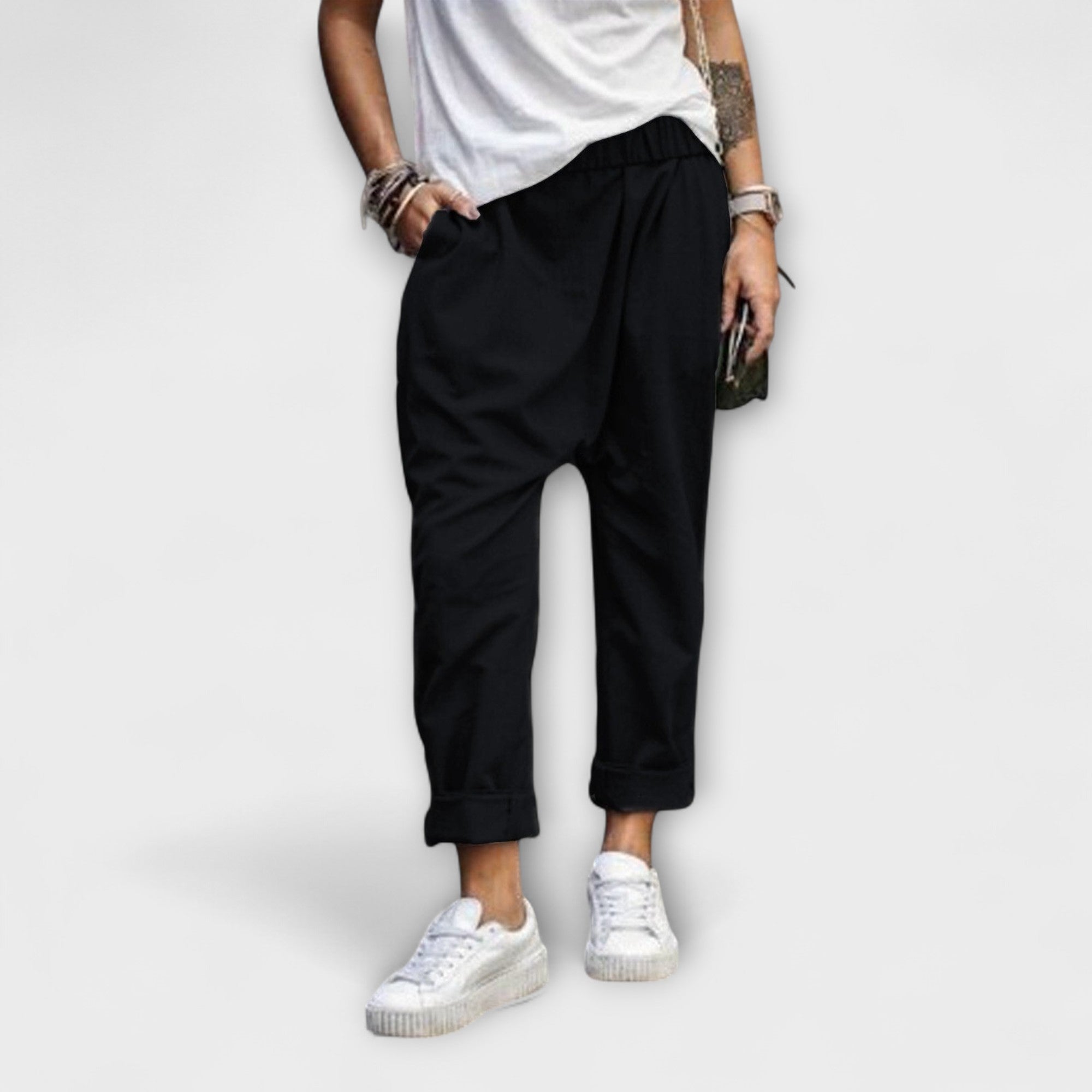 Black wide-leg pants with cuffed ankles and relaxed fit.